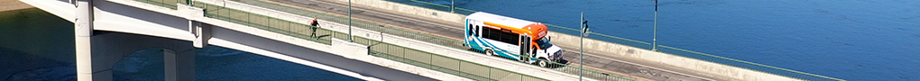 Kitsap Transit On-Demand bus traveling across a bridge. 