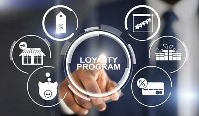 Image of man pushing a loyalty program button with other illustrations circling. 