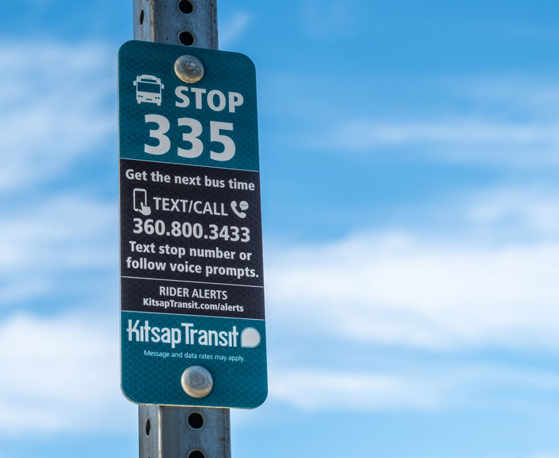 Text for next arrival using stop number. Image of sign on pole